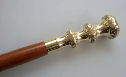 https://areevadecor.com/wp-content/uploads/2023/02/designer-brass-knob-style-golden-handle-with-brown-wooden-walking-stick-cane-500x500-1.webp